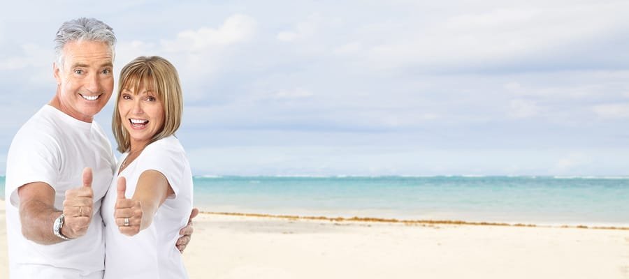 Happy senior couple on the beach. Exotic luxury resort.